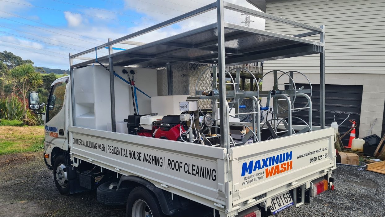 Truck-mounted wash rig — customer-installed tank, engine pump and twin hose reels under a galvanised canopy, plumbed to suit by Softwash Source