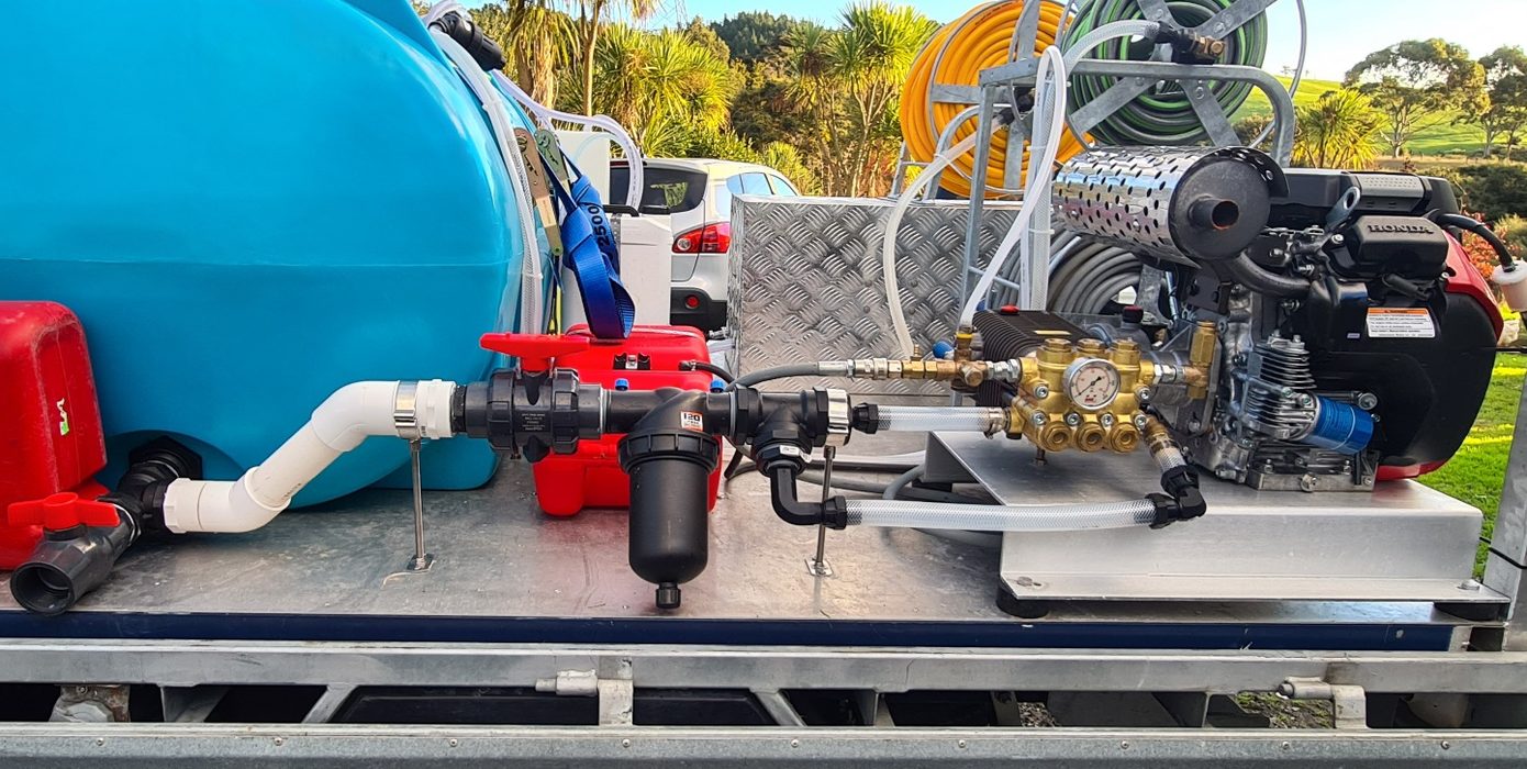 Honda engine driving a triplex pressure washer pump with pressure gauge, plumbed on a Softwash Source build